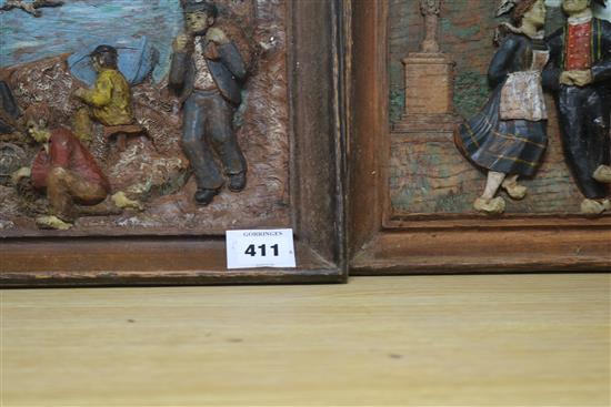 A pair of 19th century Brittany polychrome painted carved wood relief panels Fisherfolk and Village Dance 22 x 34cm